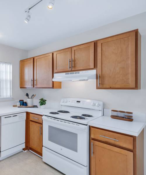 Kitchen with white appliances at Muirwood in Farmington Hills, Michigan