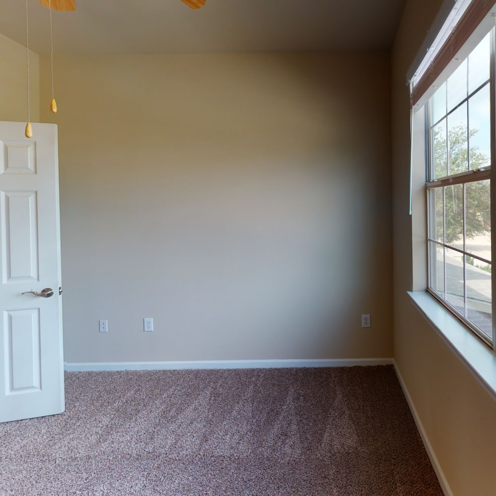 Open-concept layout with carpeted flooring throughout the bedrooms of a townhome at Oaks Estates of Coppell in Coppell, Texas