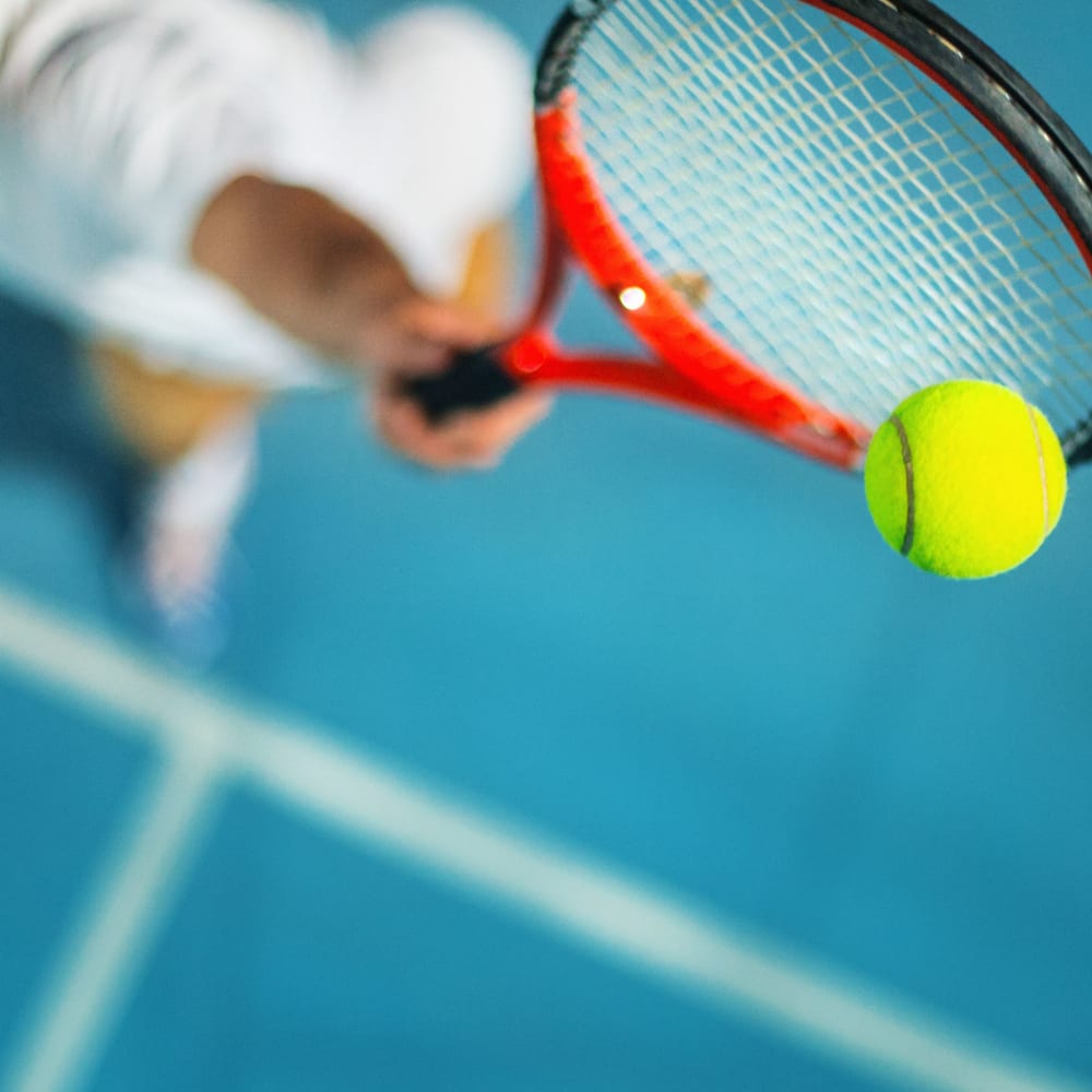 Resident playing tennis at Trinity at the Hill in Carrboro, North Carolina