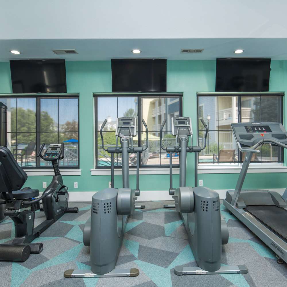 Fitness center with treadmills and television at One Belmar Place in Lakewood, Colorado