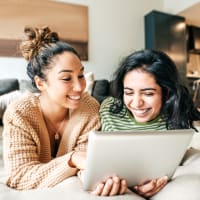 Two women looking at a tablet at Ravella at Town Center in Jacksonville, Florida