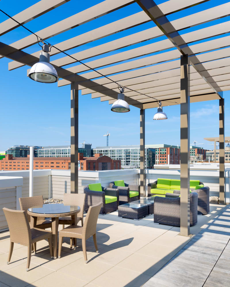 Arbor providing partial shade over the rooftop lounge at The Bixby in Washington, District of Columbia