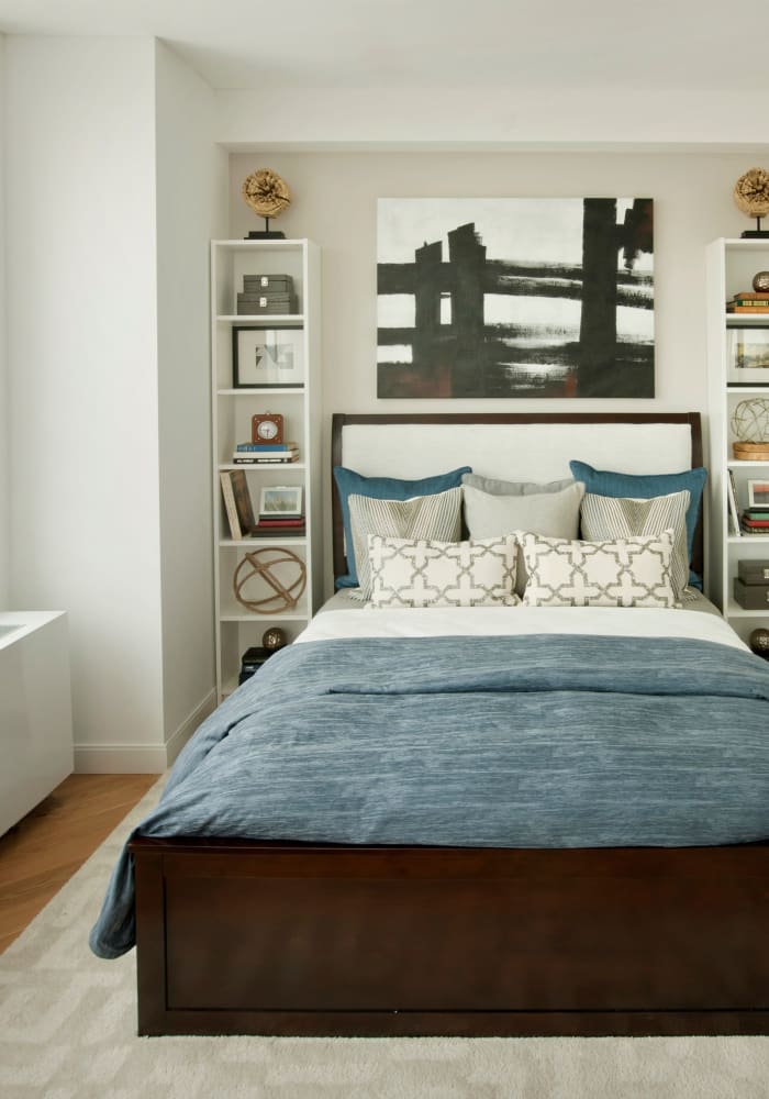 Model bedroom with built-in shelving at The Alexander in Rego Park, New York