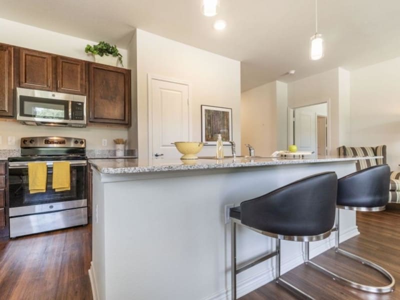 Fully-equipped kitchen with a large island at Auberge of Tyler in Tyler, Texas