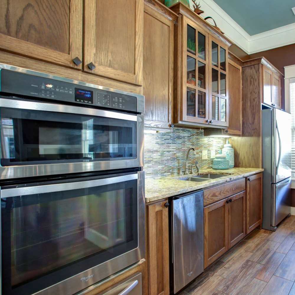 Modern kitchen with sleek stainless steel appliances and elegant granite countertops at Avonlea Square in Smyrna, Georgia.
