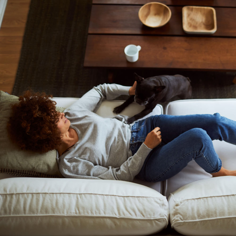 Resident and her pup relaxing in their apartment home at Overlook Point Apartments in Salt Lake City, Utah
