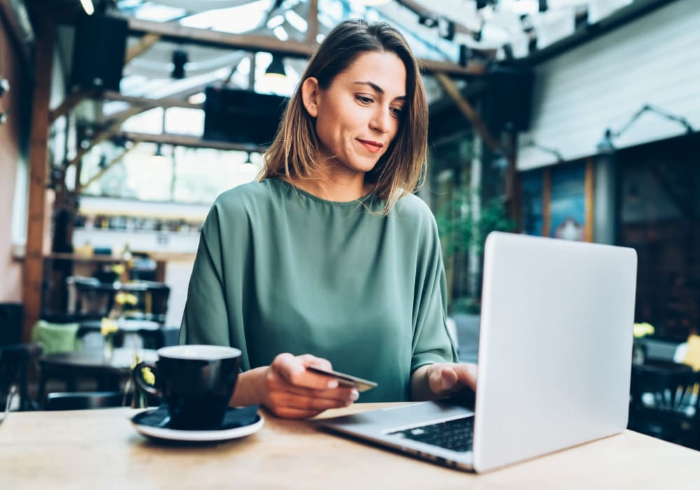 Woman working from a local coffee shop near The Abbey at Energy Corridor in Houston, Texas