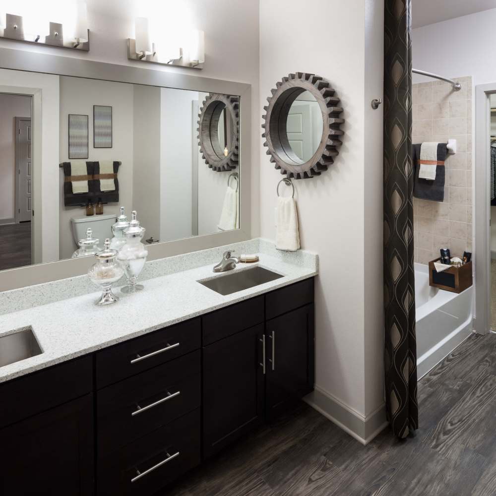 Bathroom with large mirror at Pike West Commerce in Dallas, Texas