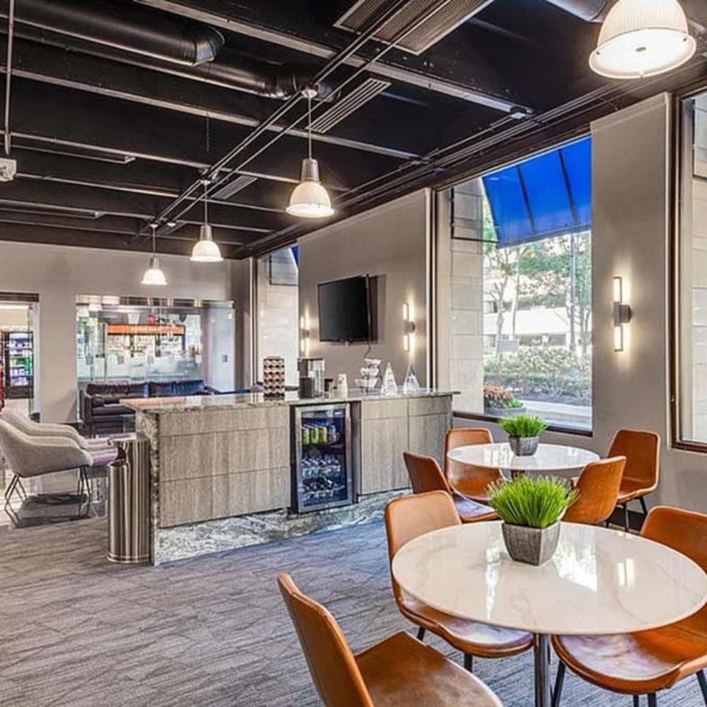 Modern community spaces with kitchen and dining area at Riverfront Towers in Detroit, Michigan