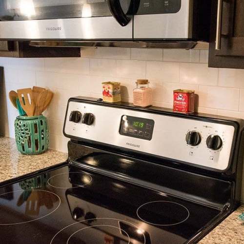 Apartment kitchen with modern stove and appliances at Belle Meade in Wilmington, North Carolina