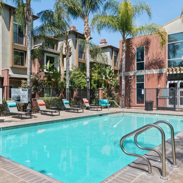Person swimming underwater in the pool at Ontario Town Square Townhomes in Ontario, California