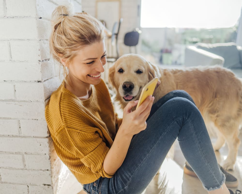 Resident sitting next to her dog at Clocktower Mill and Velvet Mill Apartments in Manchester, Connecticut