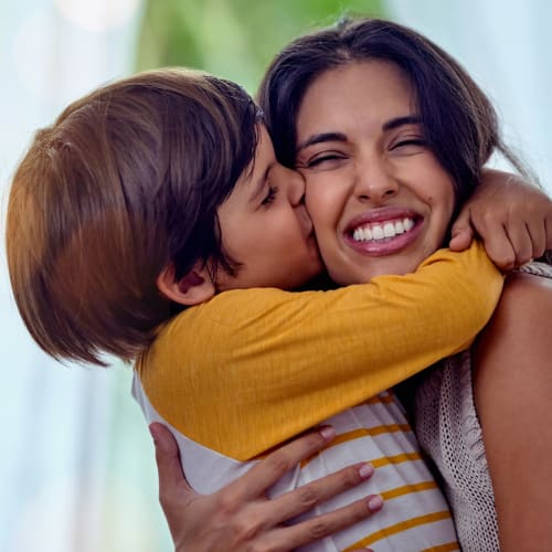 A mother and child embracing at Silver Strand II in Coronado, California