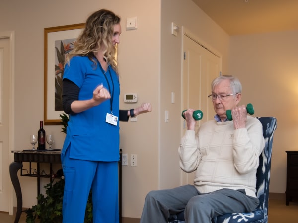 Nurse helping a resident with weights at Careage Home Health in Bellevue, Washington. 