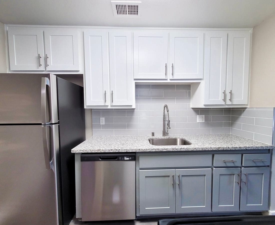 1-BR Apartments in Dixon, CA - The Mews at Dixon Farms - Kitchen with Renovated Finishes, Granite-Style Countertops, White Cabinets, and Appliances. at The Mews At Dixon Farms in Dixon, California