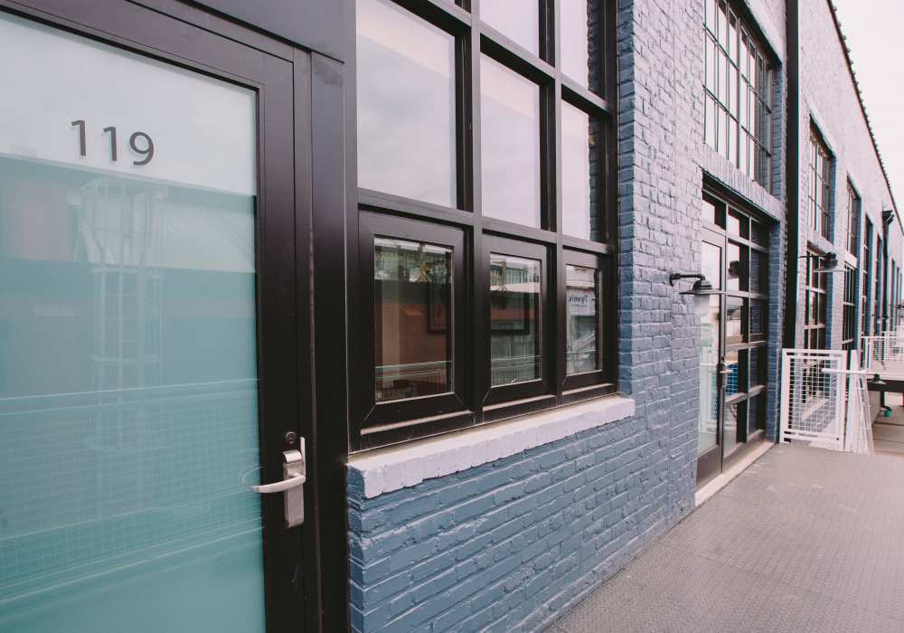 Exterior side view of brick building entrance with unit number signage at City View Lofts in Richmond, Virginia