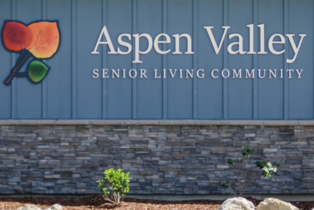 Multicolored leaf Logo and signage outside of Aspen Valley Senior Living in Boise, Idaho