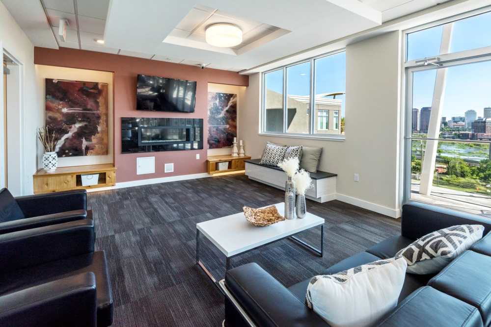 Clubhouse lounge area with wall-mounted TV at Terraces at Manchester in Richmond, Virginia