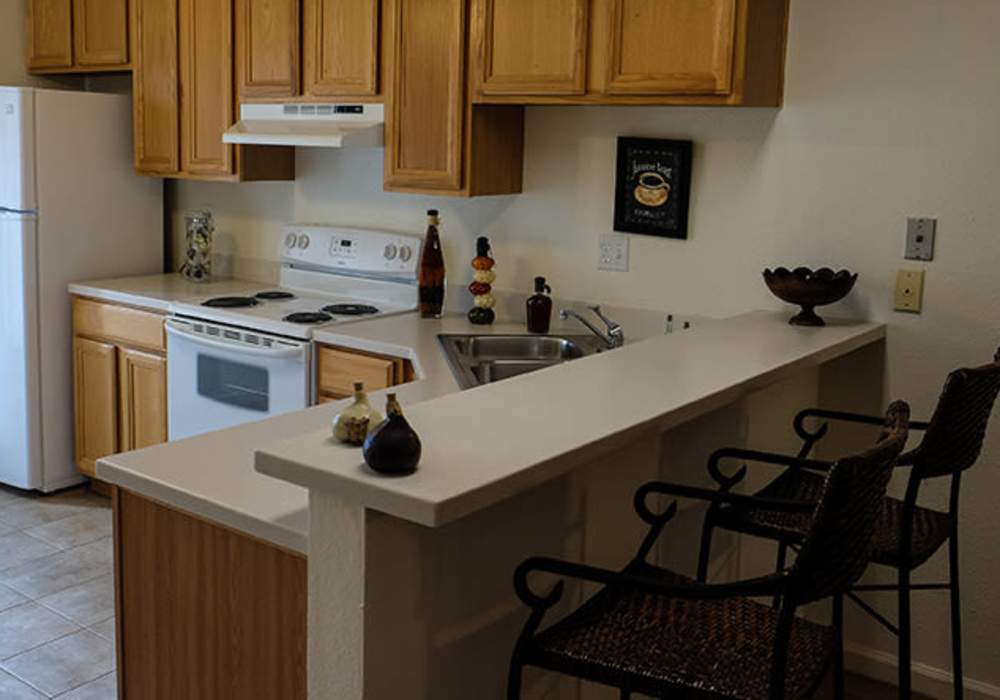 Kitchen with appliances at The Hills in San Diego, California