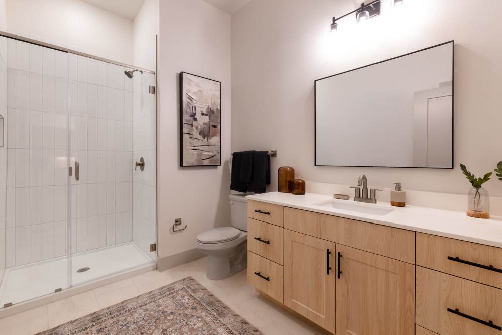 Spa shower with extra storage in the bathroom at Winston Heights. 