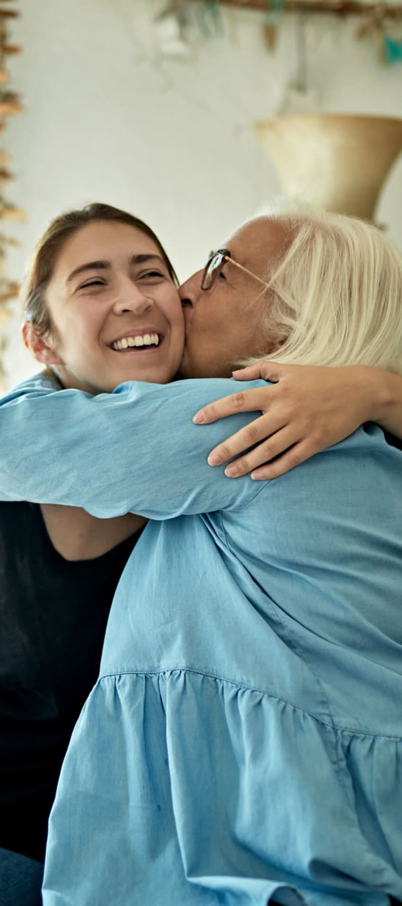 Resident hugging a caretaker at a WISH community