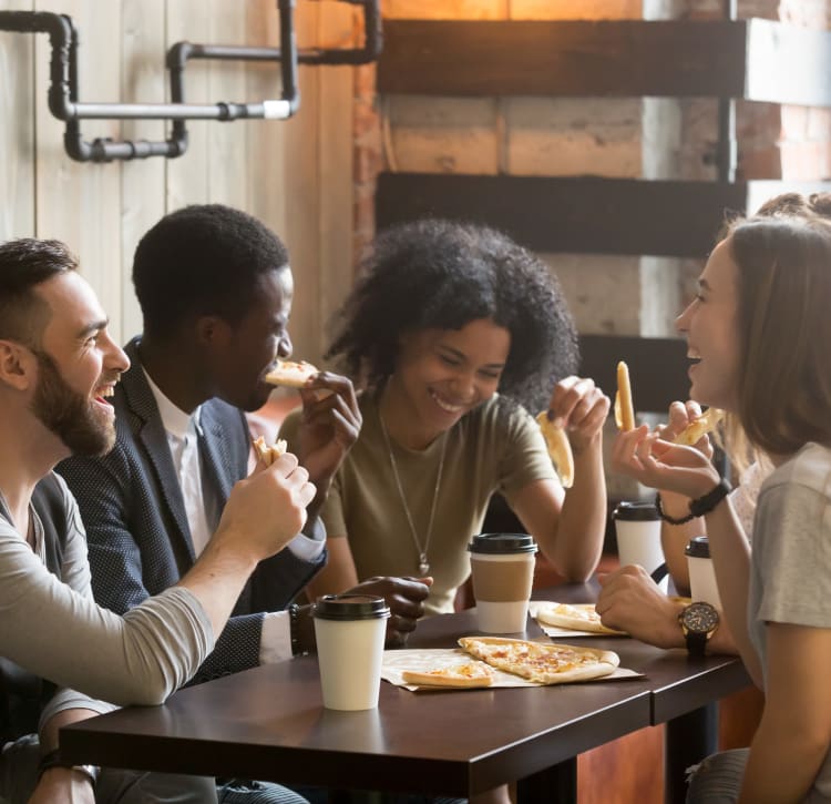 Resident friends enjoying a snack with their coffee at their favorite café near Verse Seattle in Seattle, Washington