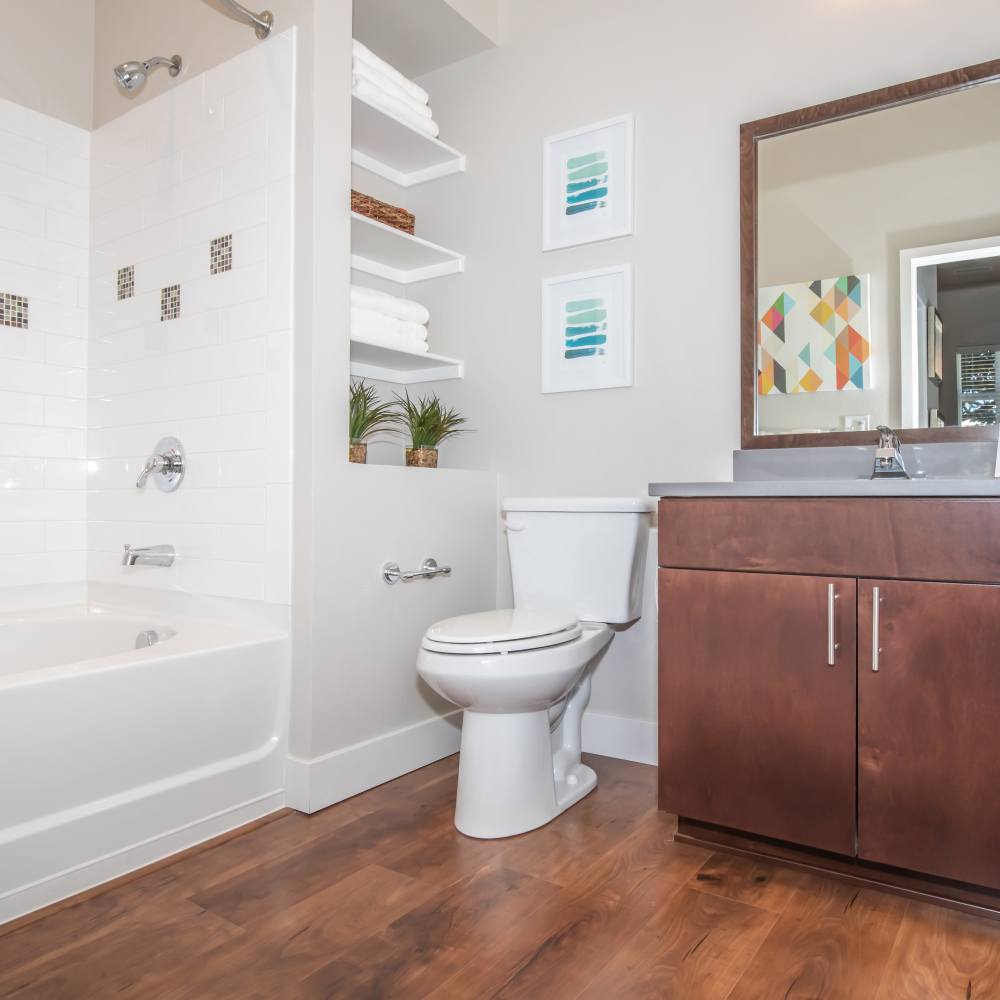Bright bathroom with sink, commode and bathtub at Park Place Olde Town Apartments in Arvada, Colorado