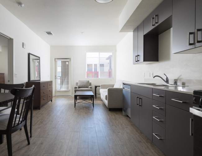 Modern kitchen and spacious living area with natural light at Antioch Family & Senior Apartments in Antioch, California