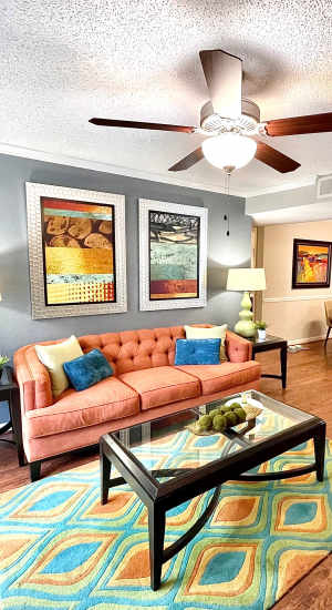 Living room with ceiling fan at The Abbey at Inverness in Birmingham, Alabama