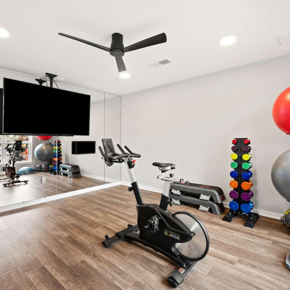 Fitness center with cycling and television at Neo Vantage Point in Maryland Heights, Missouri