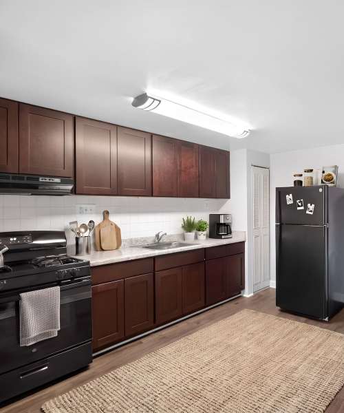 Kitchen with black appliances near Pleasant View Townhomes in Baltimore, Maryland