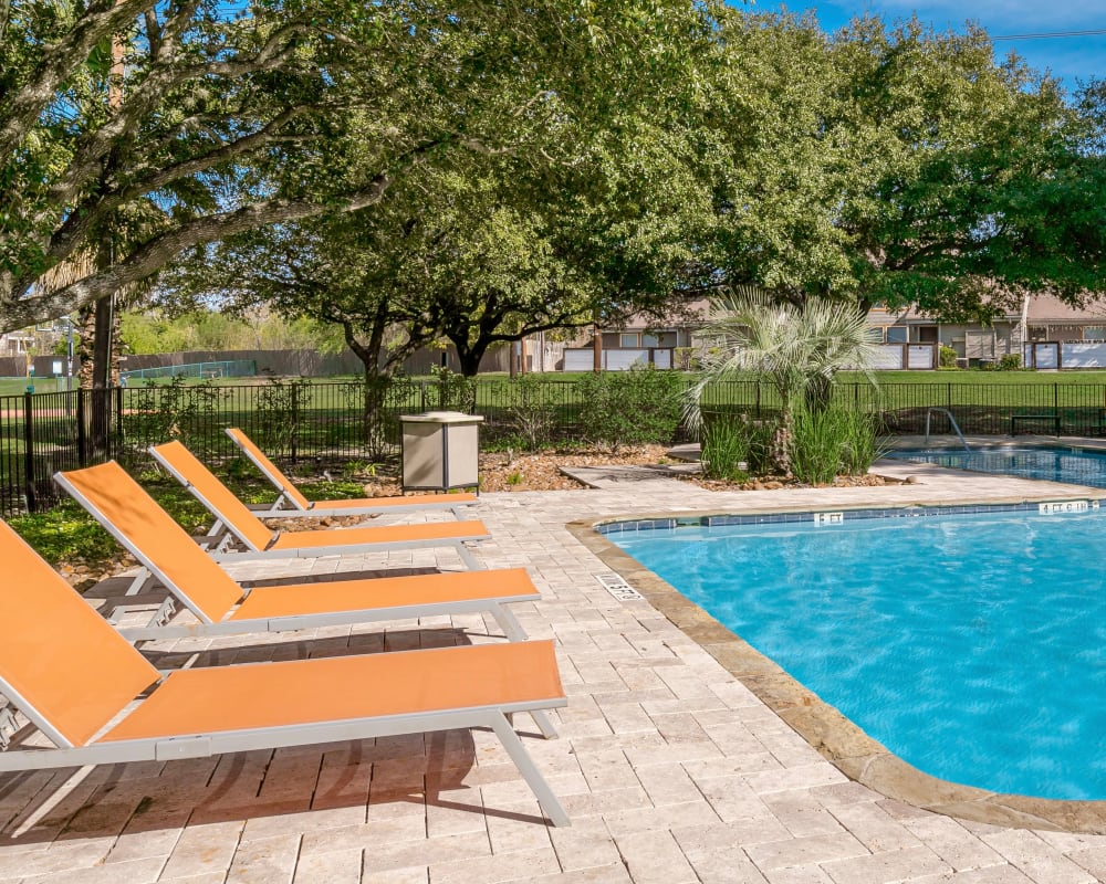 Lounge chairs by the pool at The Fredd Townhomes in San Antonio, Texas