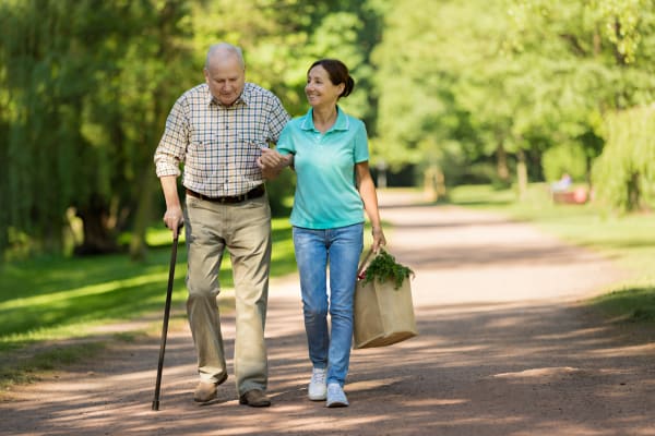 Caregiver helping a resident with groceries at WellQuest of Granite Bay in Granite Bay, California