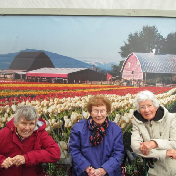 3 women standing in front of a mural of tulips at Quail Park of Lynnwood in Lynnwood, Washington