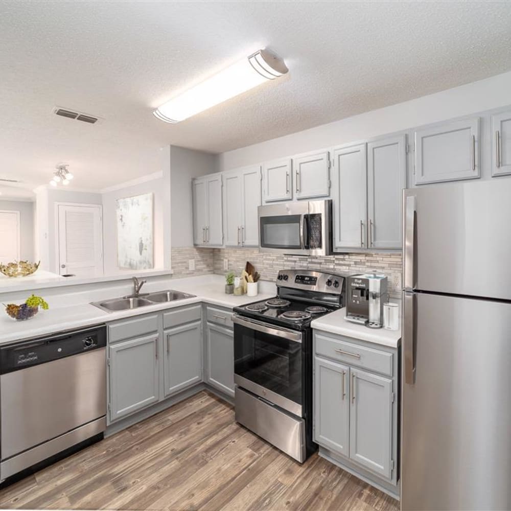 An apartment kitchen with stainless steel appliances at Astoria in Mobile, Alabama