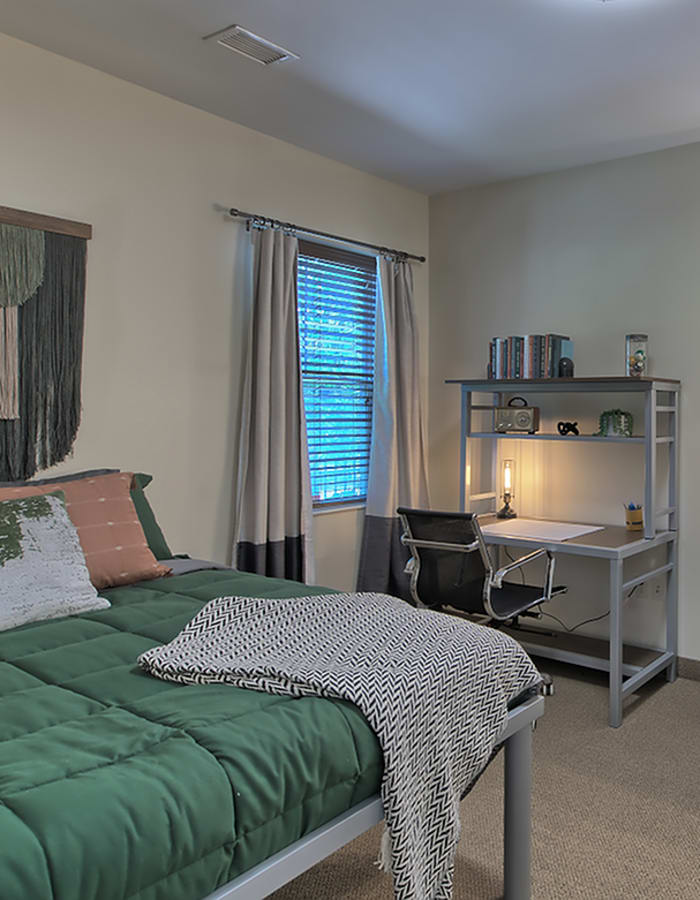 Bedroom with desk and large window at Twin River Commons in Binghamton, New York 