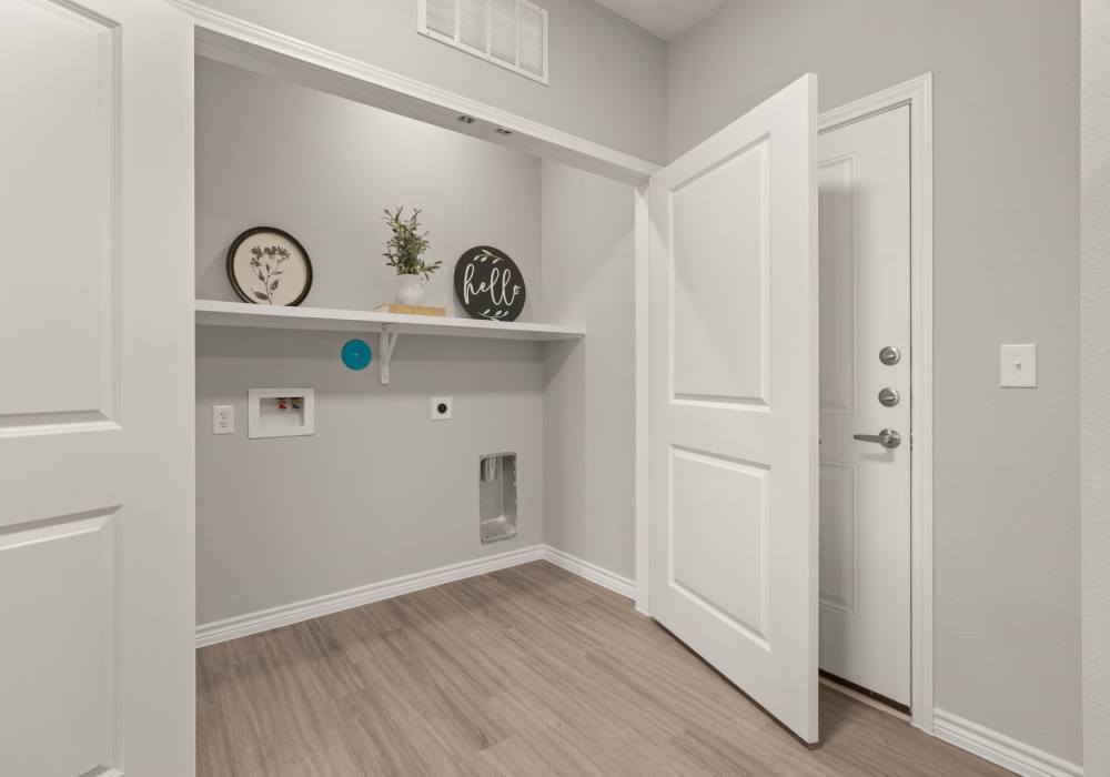 In-home laundry room with shelving at Walnut Springs in Seguin, Texas