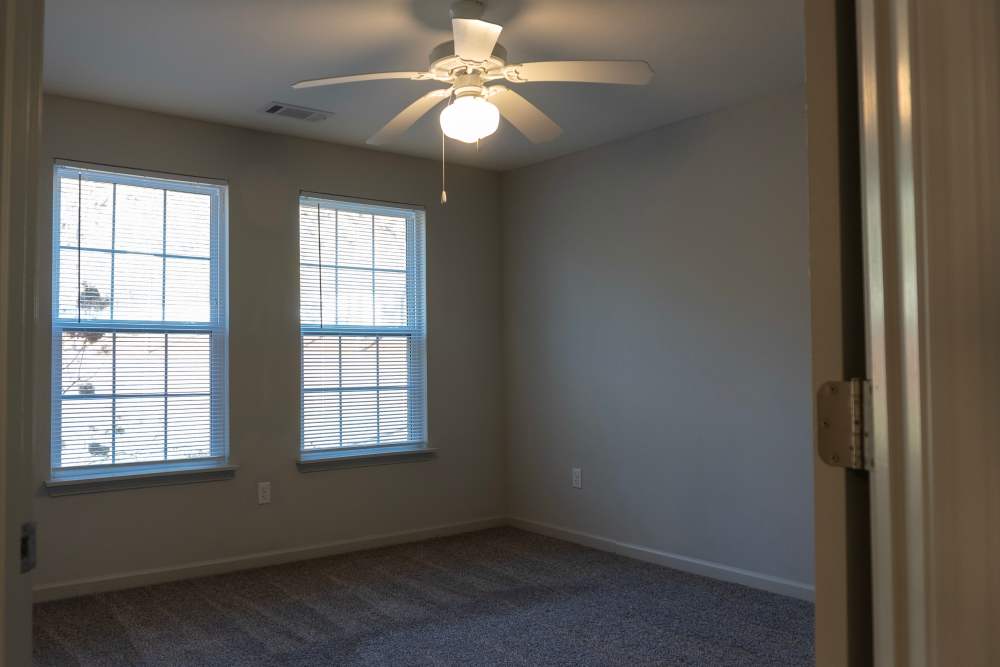 Bedroom with ceiling fan and windows at Redland Creek in Lawrenceville, Georgia