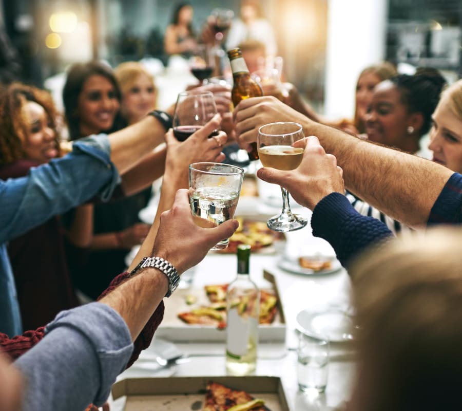 Group of resident friends out for a meal at their favorite restaurant and raising a toast to the good life at Domus on the Boulevard in Mountain View, California