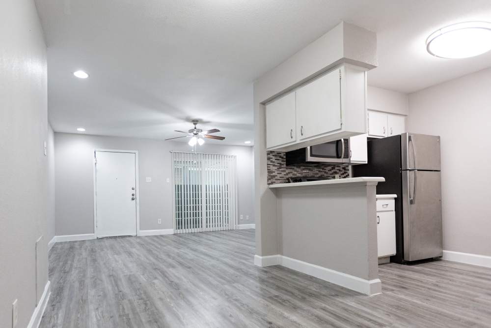 Charming modern kitchen with sleek finishes and open living space at San Mateo Forest in Dallas, Texas.