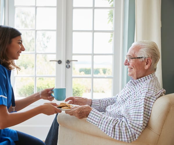 Resident having a hot drink delivered to him at Governor's Pointe in Mentor, Ohio