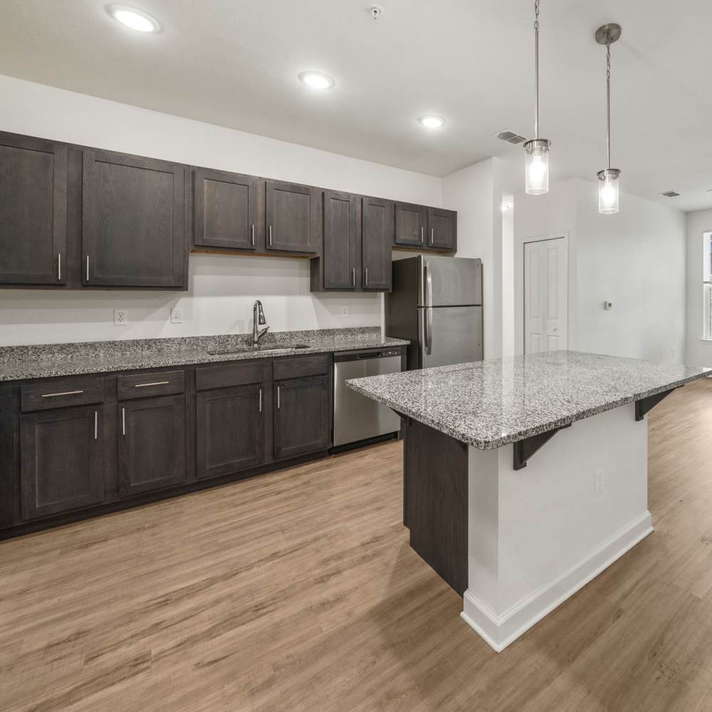 Spacious island kitchen with pendant loights at Fletcher Black in Panama City, Florida
