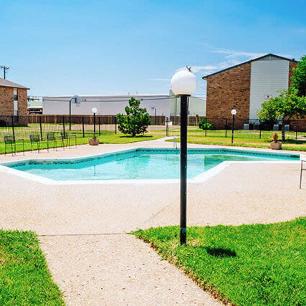 Swimming pool with green lawn around at Cross Timbers At Grand Street in Amarillo, Texas
