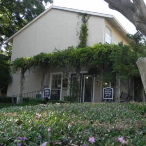 Entrance to the leasing office with a vine-covered pergola at Highlands of Duncanville in Duncanville, Texas