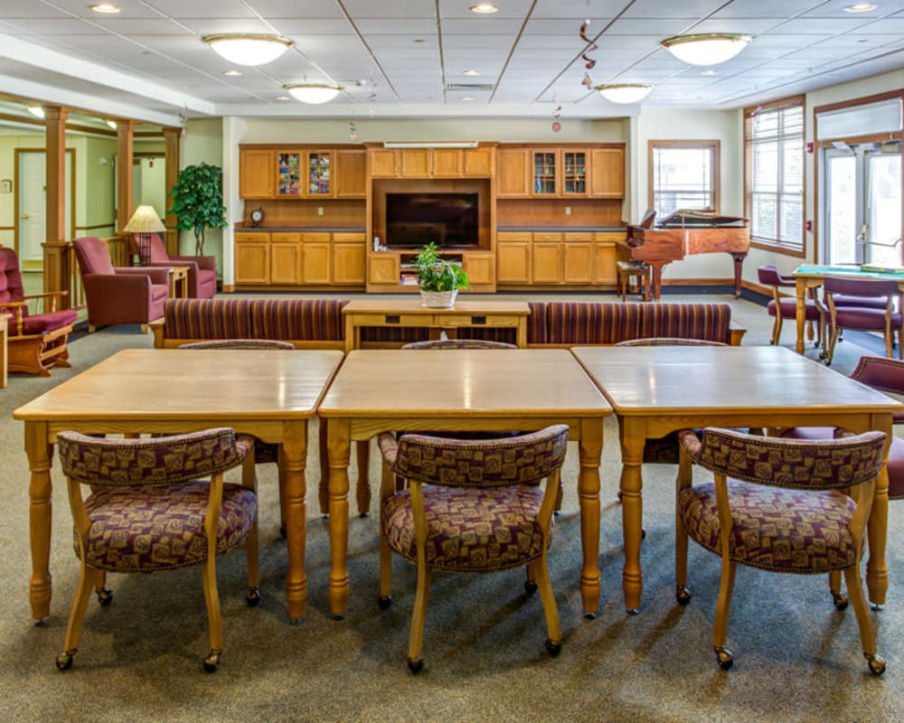 Spacious activity room with TV and piano at Prairie Hills Independence in Independence, Iowa.