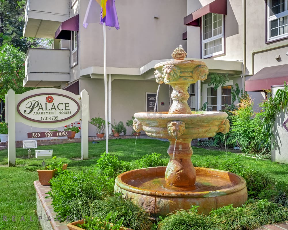 A welcoming from entrance with a fountain at Palace Apartments in Concord, California