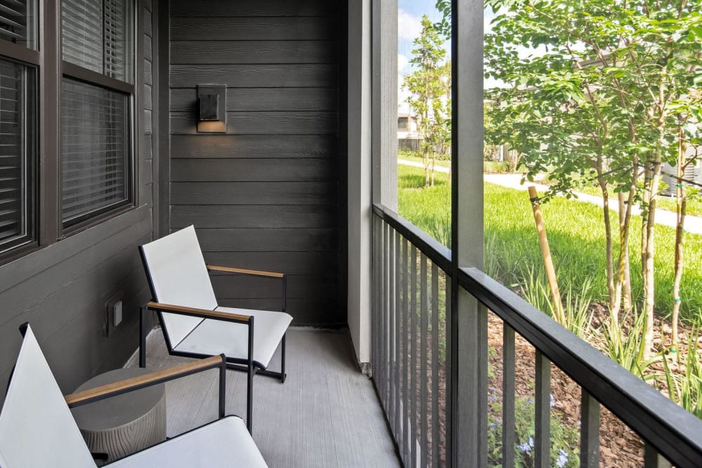 private balcony with seating overlooking a maintained landscape at Las Palmas in Fort Myers, Florida