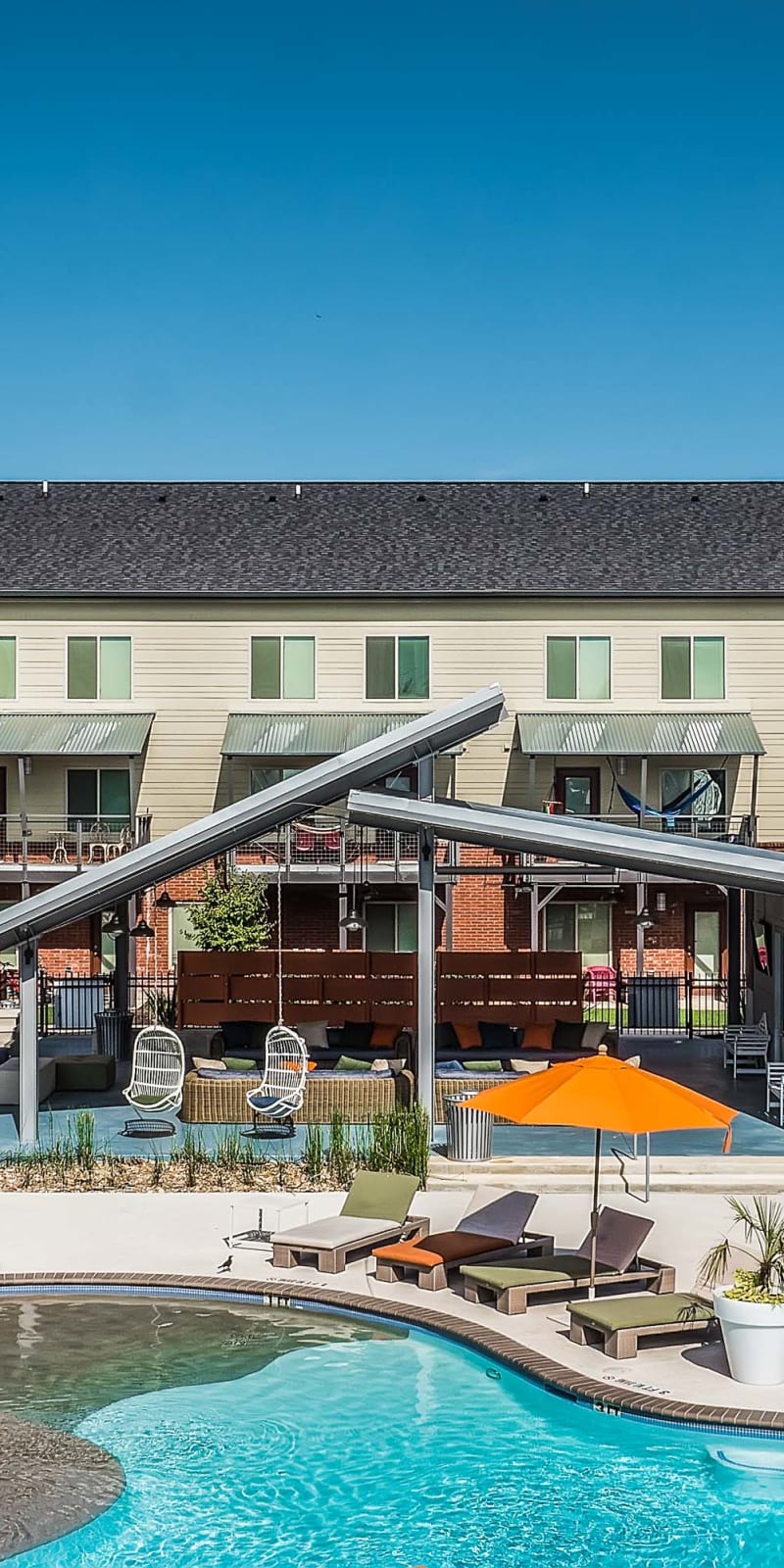 Beach-entry pool and outdoor pavilion space at The Thompson in San Marcos, Texas