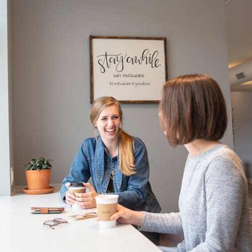 Two residents drinking coffee at West Towne in Ames, Iowa