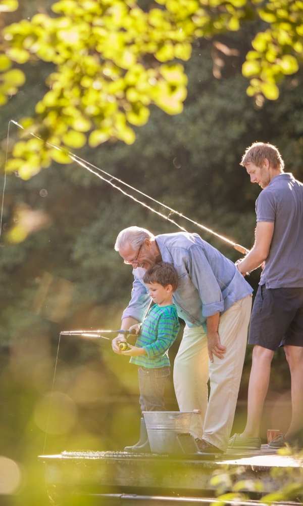 Residents catching fish with a hook nearby The Abbey on Lake Wyndemere in The Woodlands, Texas